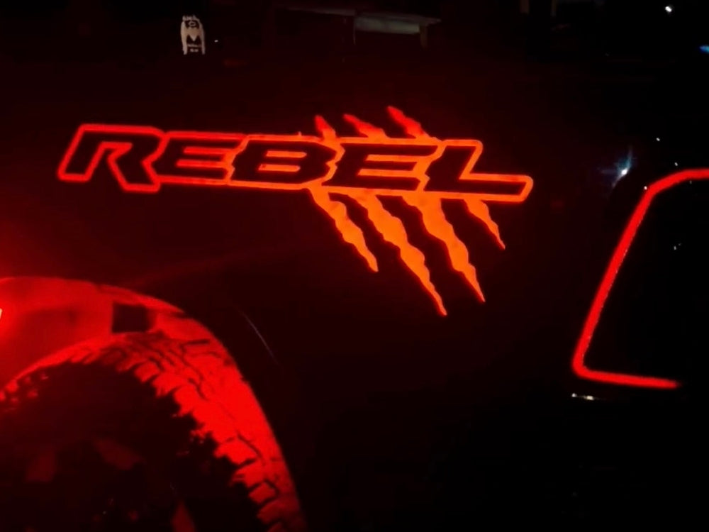 Black RAM Rebel truck with stylish reflective red claw mark logo bedside graphics