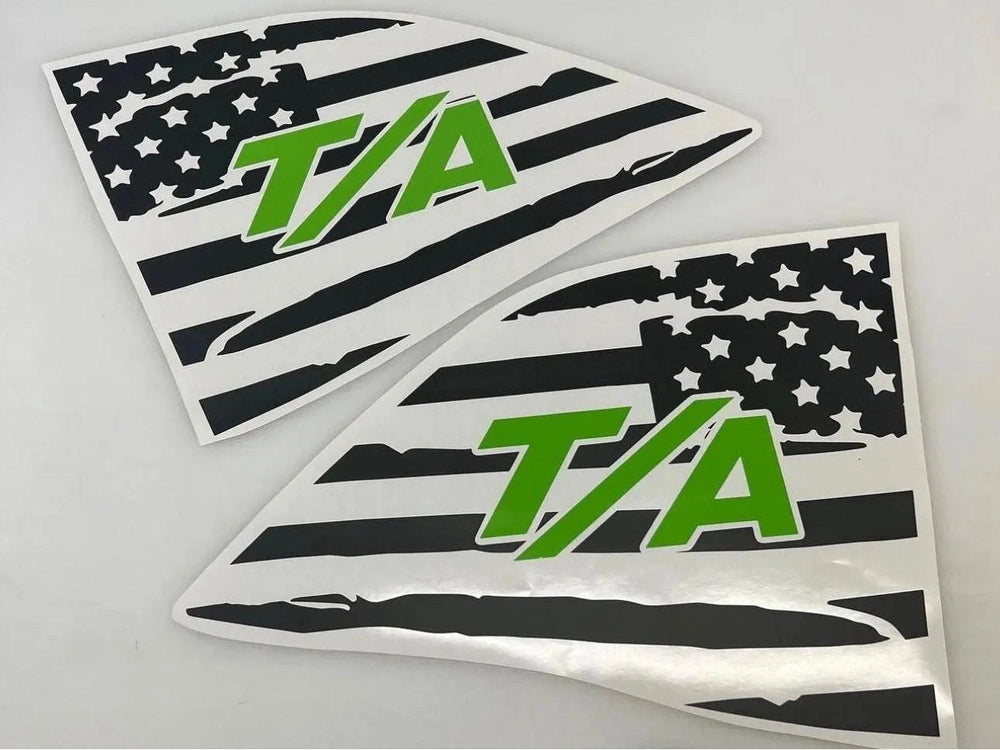 Challenger quarter window decals featuring T/A logo in green on black and white American flag design, showcasing two triangular stickers for both sides of the vehicle