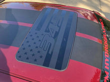 Load image into Gallery viewer, Dodge Challenger sunroof with patriotic R/T decal featuring American flag design in dark blue on red car exterior, showcasing custom vinyl application for muscle car enthusiasts