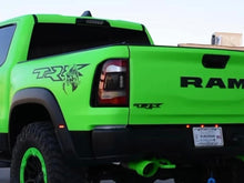 Load image into Gallery viewer, Bright green RAM TRX pickup truck with black TRX logo and RAM branding on side, showcasing bedside decals and aggressive off-road styling