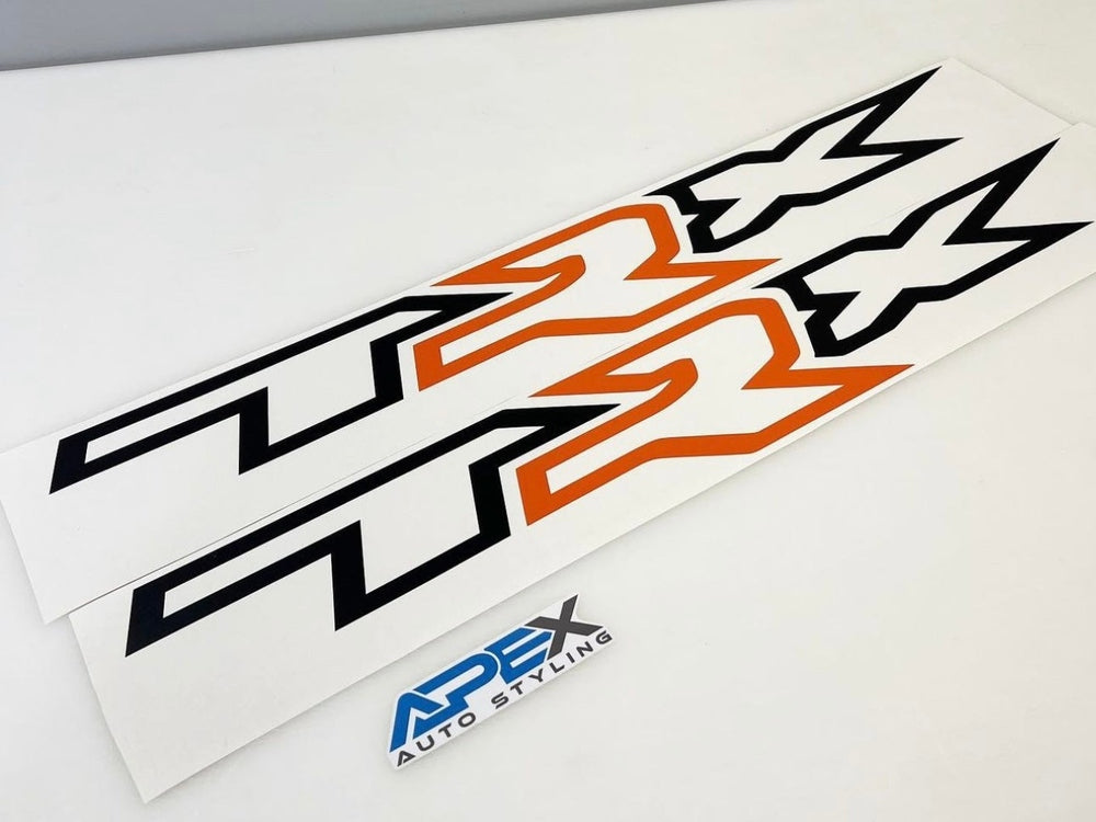 RAM TRX bedside decals featuring black TRX logo with orange R, custom design for truck customization, displayed on white surface with Apex Auto brand logo