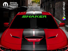 Load image into Gallery viewer, Red Dodge Challenger with black racing stripes and green &#39;SHAKER&#39; windshield decal, parked on urban street. Official licensed product logo in top left corner.