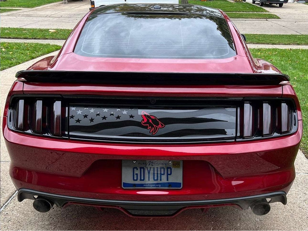 Red Ford Mustang rear view showcasing custom decklid decal with American flag design and Coyote logo, enhancing the sleek appearance of the S550 model.
