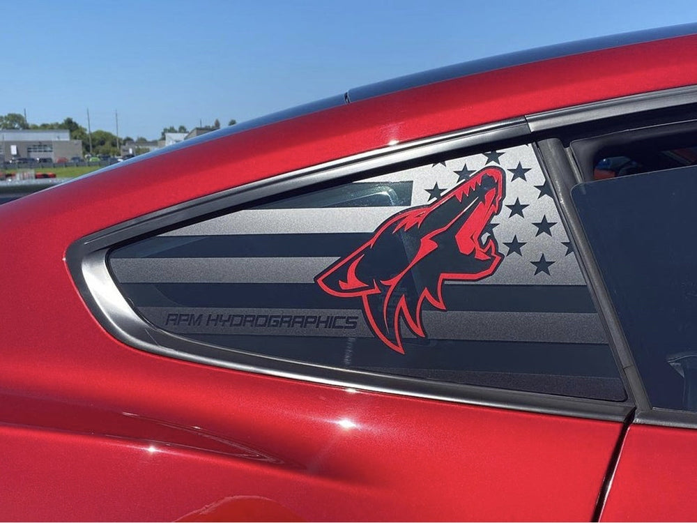 Red Ford Mustang quarter window with custom decal featuring black American flag design and red coyote logo, showcasing S550 Mustang Quarter Window Decals product on a sunny day