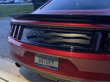 Load image into Gallery viewer, Red S550 Mustang rear view showcasing custom decklid decal featuring American flag design with Coyote text, enhancing the car&#39;s sleek appearance and patriotic styling. License plate visible, parked in outdoor setting.