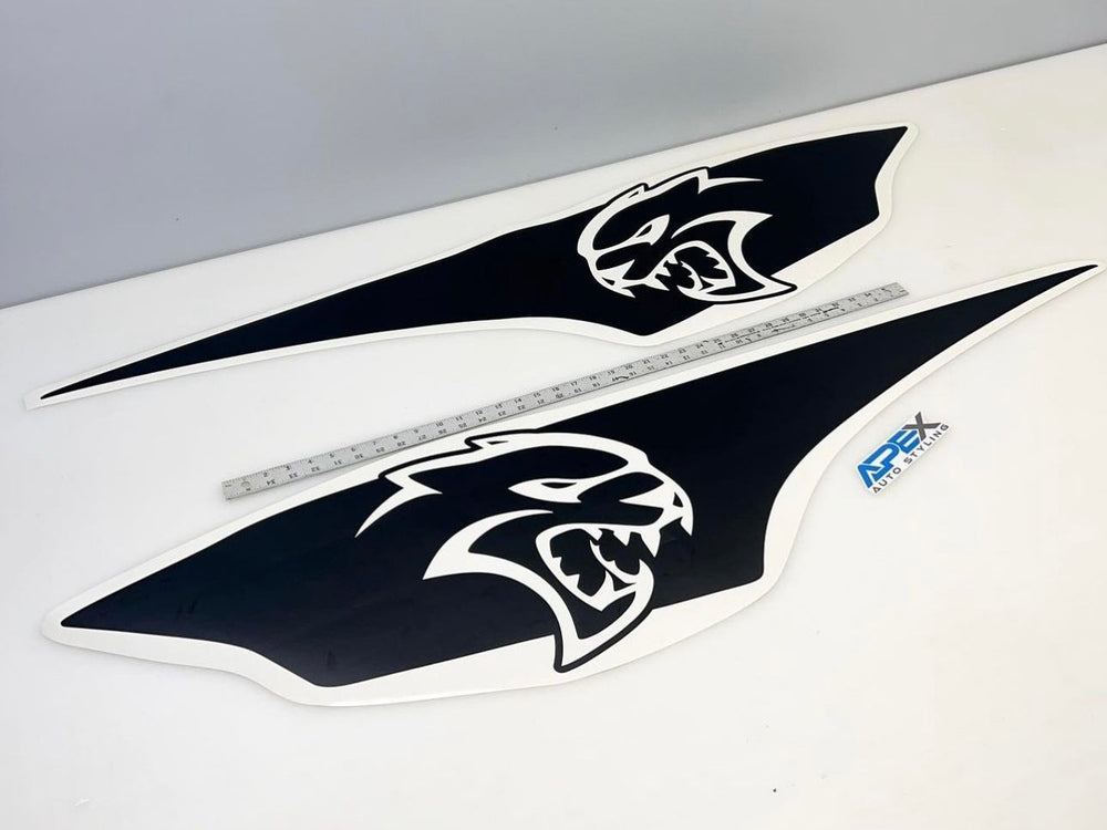 RAM TRX Ignition Style Bedside Decals featuring Hellcat logo, shown as two large black vinyl stickers with white fierce cat head design, displayed alongside a measuring ruler for size reference