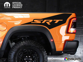 Orange RAM truck rear quarter panel with black TRX Ignition Edition style decal featuring SRT logo, showcasing custom vinyl graphics for vehicle customization