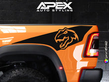 Load image into Gallery viewer, Orange RAM TRX truck with custom black bedside decal featuring T-Rex dinosaur logo, showcasing Apex Auto Styling products for vehicle customization and personalization