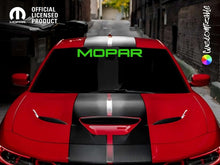 Load image into Gallery viewer, Red Jeep Grand Cherokee with black racing stripes and bright green MOPAR logo on windshield banner, parked in urban alley. Official licensed product logo visible in corner.