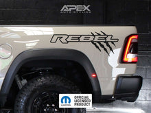 Load image into Gallery viewer, RAM Rebel truck bedside featuring custom decal with &#39;REBEL&#39; text and claw mark design, showcasing rugged styling and personalization options for the vehicle&#39;s exterior