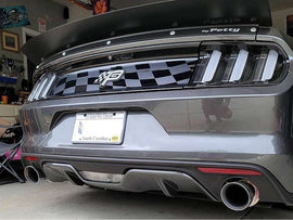 Rear view of a silver S550 Mustang showcasing a checkered flag pattern on the grille, dual exhaust pipes, and a sleek decklid design, highlighting the sporty and customized appearance of the vehicle.