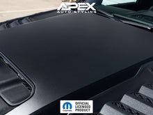 Load image into Gallery viewer, Close-up of a matte black RAM TRX hood decal applied to a vehicle, showcasing the solid color design and factory-style fitment. APEX Auto Styling logo visible in the corner, along with an official licensed product emblem.
