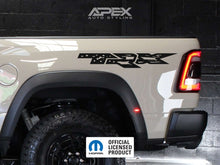 Load image into Gallery viewer, RAM TRX bedside decal featuring OEM logo and US flag design on a white truck, showcasing the product&#39;s appearance and placement on the vehicle&#39;s side panel near the rear wheel arch