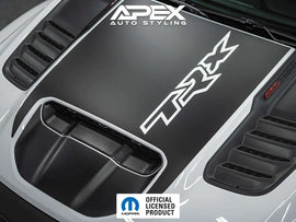 Black RAM TRX hood decal with TRX logo cutout installed on a vehicle hood, showcasing OEM-style design with contrasting white logo against dark background. Apex Auto Styling branding visible in corner.