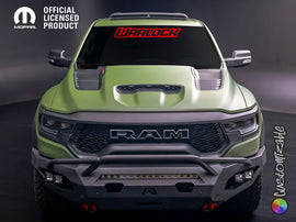 Green RAM truck with red Warlock windshield banner decal, aggressive front grille, and off-road bumper, showcasing customization options for RAM Rebel owners