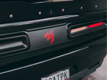 Load image into Gallery viewer, Closeup of black Dodge Challenger taillight divider with red Angry Hornet logo decal, showcasing customizable design and precise fit between taillights