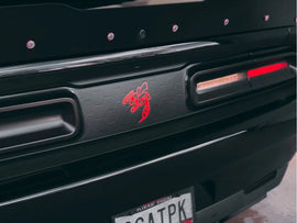 Closeup of black Dodge Challenger taillight divider with red Angry Hornet logo decal, showcasing customizable design and precise fit between taillights
