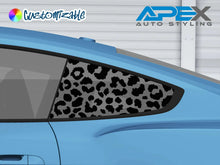 Load image into Gallery viewer, Blue Ford Mustang S550 with cheetah print quarter window decal, showcasing custom styling for 2015-2023 models. Precision-cut black pattern allows light through, enhancing the car&#39;s unique appearance.