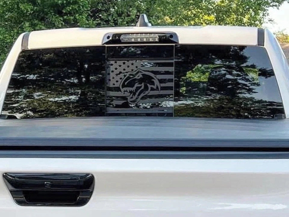 RAM truck rear window with custom TRX Dino logo decal featuring American flag design in black, showcasing sleek and patriotic styling for 2009+ models