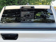 Load image into Gallery viewer, RAM truck rear window with custom TRX Dino logo decal featuring American flag design in black, showcasing sleek and patriotic styling for 2009+ models