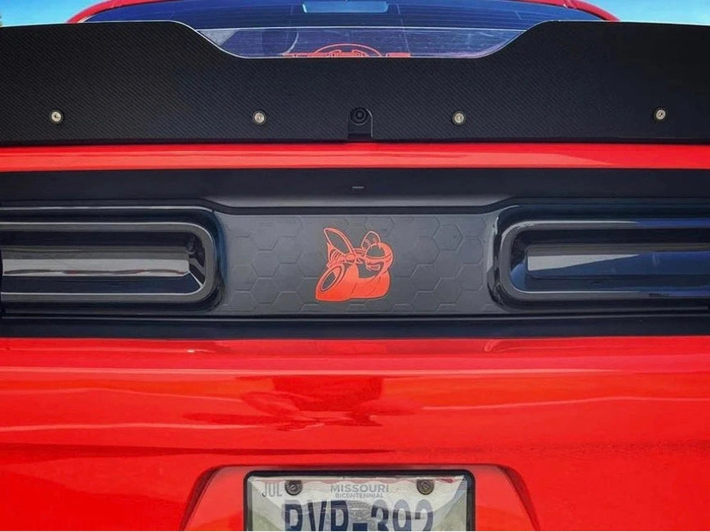 Red Dodge Challenger rear view showing taillight area with black divider featuring orange Scat Pack logo decal, customized appearance for 2015+ models