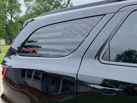 Dodge Durango quarter window decal featuring American flag design and SRT logo in red, applied to a silver SUV's rear side window, showcasing custom vinyl graphics for vehicle personalization