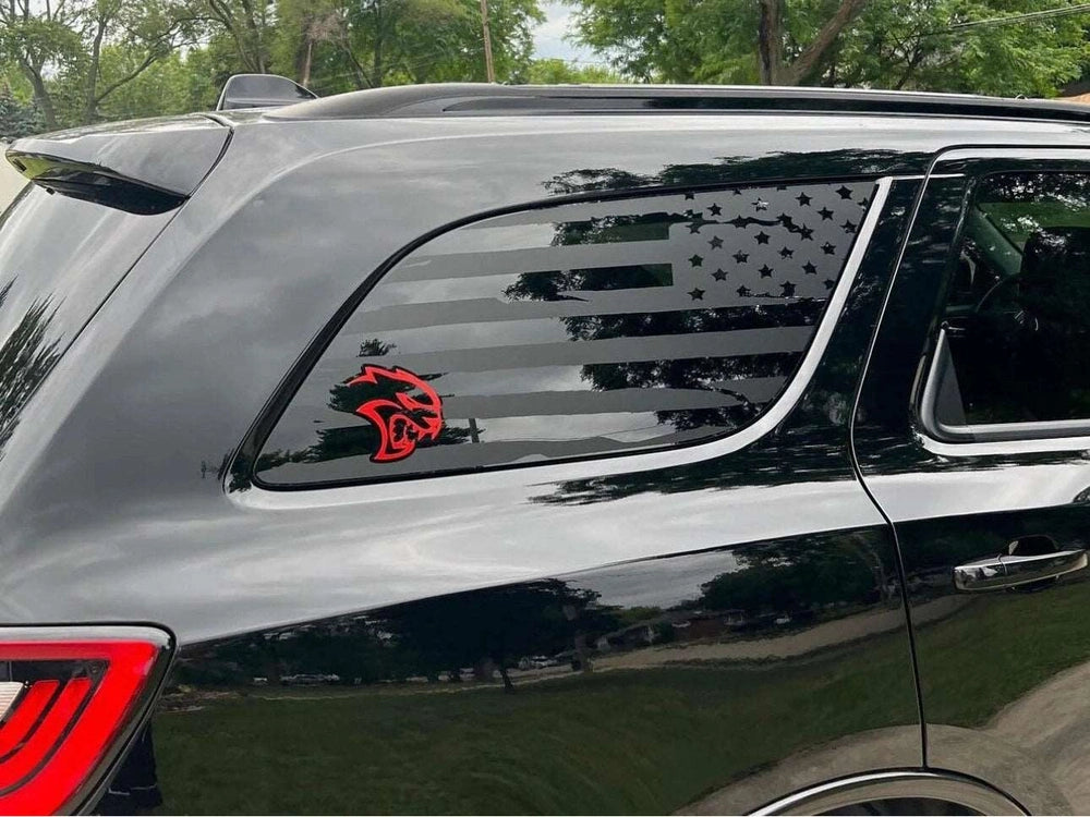 Dodge Durango quarter window with custom decal featuring American flag design and red Hellcat logo, showcasing patriotic and sporty aesthetics for vehicle customization