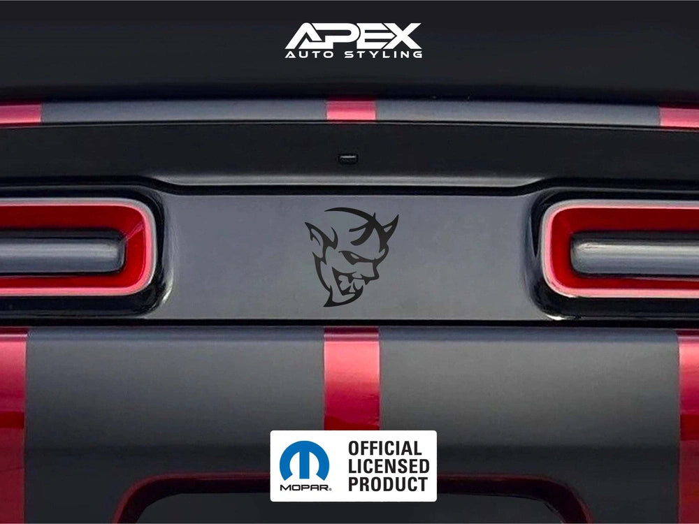 Dodge Challenger taillight divider with Demon logo decal, showcasing Apex Auto Styling product on a red and black striped vehicle rear, with official Mopar licensed product badge.