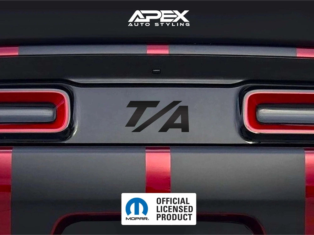 Dodge Challenger taillight divider with T/A logo decal, showcasing customizable design options for enhanced rear appearance. Black decal with raised pattern visible between red taillights on gray vehicle body.