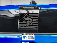 Load image into Gallery viewer, Custom Hellcat logo decal on RAM truck rear sliding window, featuring black American flag design with cat head emblem, surrounded by blue vehicle exterior