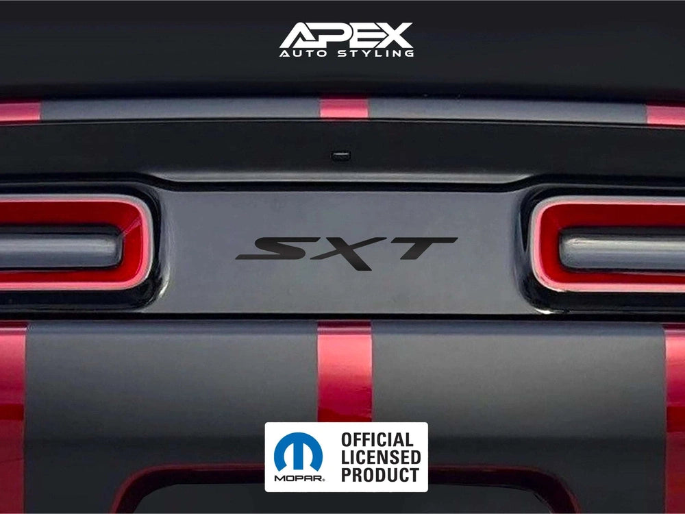 Challenger taillight divider with SXT logo decal applied, showcasing custom design between red taillights on gray and red striped vehicle rear. APEX Auto Styling and Mopar logos visible.