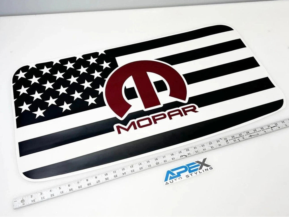 Dodge Challenger Mopar logo sunroof decal featuring American flag design with stars and stripes, showcasing the Mopar emblem in red against a black and white background, displayed on a white surface with measuring ruler for scale reference