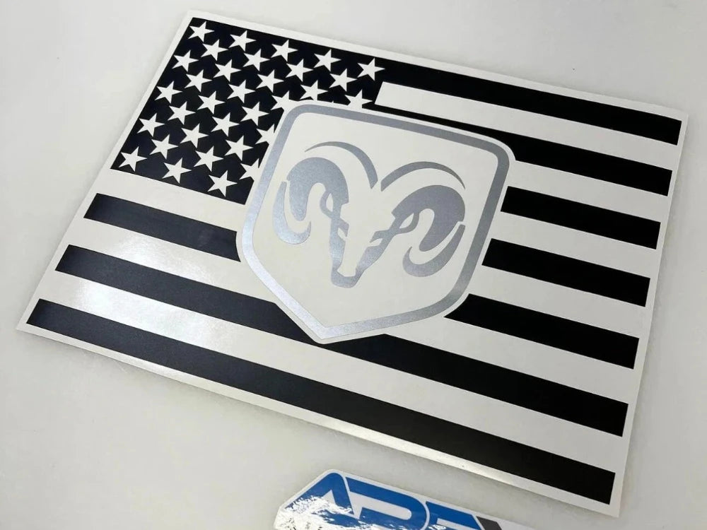 RAM logo decal on black and white American flag design for rear sliding window, showcasing custom vinyl product for 2009+ RAM pickup trucks
