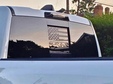 Load image into Gallery viewer, Rear sliding window of white RAM pickup truck with custom black decal featuring American flag and TRX logo, showcasing the 2009+ RAM Rear Sliding Window Decals product
