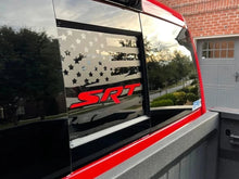 Load image into Gallery viewer, RAM truck rear sliding window with matte black American flag decal and red SRT logo, reflecting suburban neighborhood and garage door
