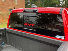 Load image into Gallery viewer, Red RAM pickup truck with SRT logo decal on rear sliding window, showcasing custom window decal product for 2009+ models against brick building backdrop