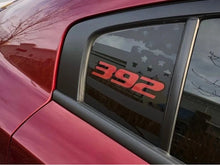 Load image into Gallery viewer, Close-up of a red Dodge Charger&#39;s quarter window featuring a custom 392 logo decal in red with stars, showcasing the sleek and sporty appearance of the vehicle&#39;s exterior design.