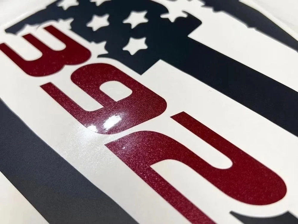 Close-up of Dodge Charger 392 quarter window decal featuring American flag design with red numbers and white stars on blue background, showcasing premium vinyl quality and precise fit for 2011-2023 models