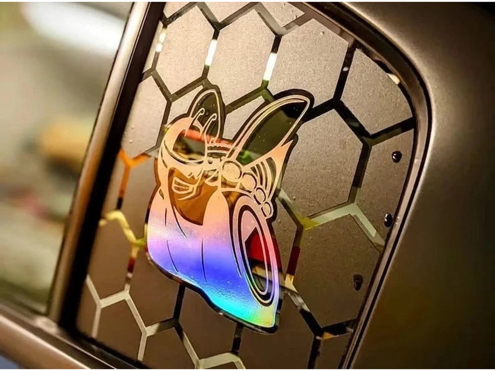 Colorful Scat Pack logo decal on Dodge Charger quarter window, featuring honeycomb pattern background and iridescent bee design, showcasing custom vinyl application for 2011-2023 models