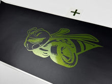 Load image into Gallery viewer, Green 1320 Superbee logo decal on black taillight divider for Dodge Challenger, showcasing a stylized bee design with racing elements. Custom vinyl accessory for enhancing vehicle appearance.