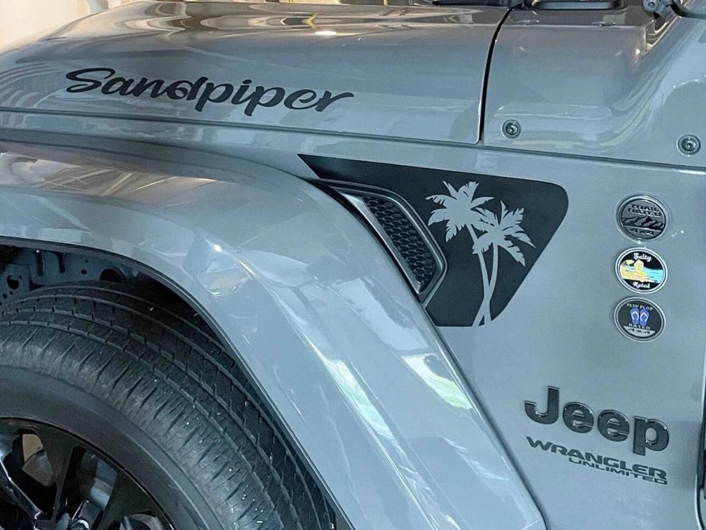 Close-up of a silver Jeep Wrangler fender with "Sandpiper" text and palm tree decal on the vent, showcasing custom fender vent decals for Jeep Wrangler and Gladiator models