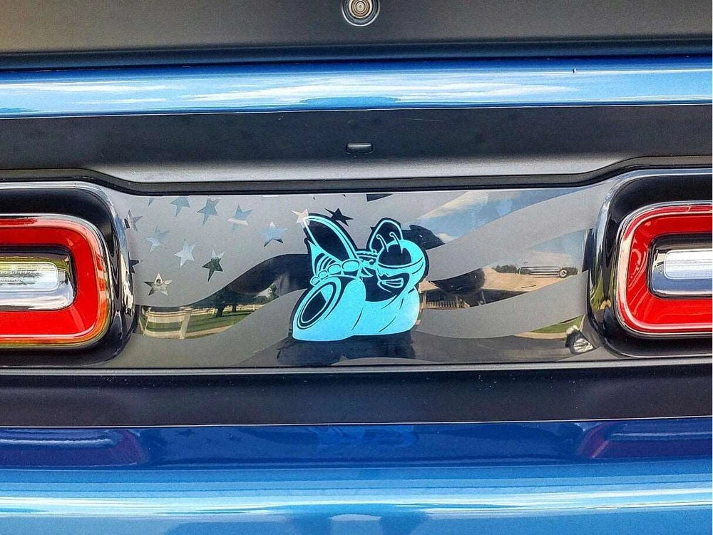 Customized Dodge Challenger taillight divider decal featuring blue Scat Pack logo and star pattern on reflective surface, between red taillights and blue body panels