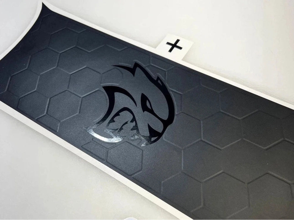 Challenger taillight divider decal with embossed hexagonal pattern and Hellcat logo in matte black finish, showcasing custom design and premium quality for 2015+ Dodge Challenger models