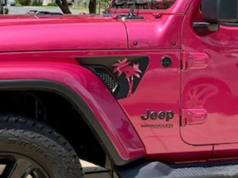 Pink Jeep Wrangler with black palm tree decal on fender vent, showcasing custom Wrangler Gladiator fender vent decals for a unique tropical look
