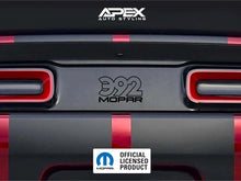 Load image into Gallery viewer, Close-up of Dodge Challenger rear taillight divider with 392 MOPAR logo decal, showcasing red taillights and custom black and red striped design. Apex Auto Styling and Mopar logos visible.