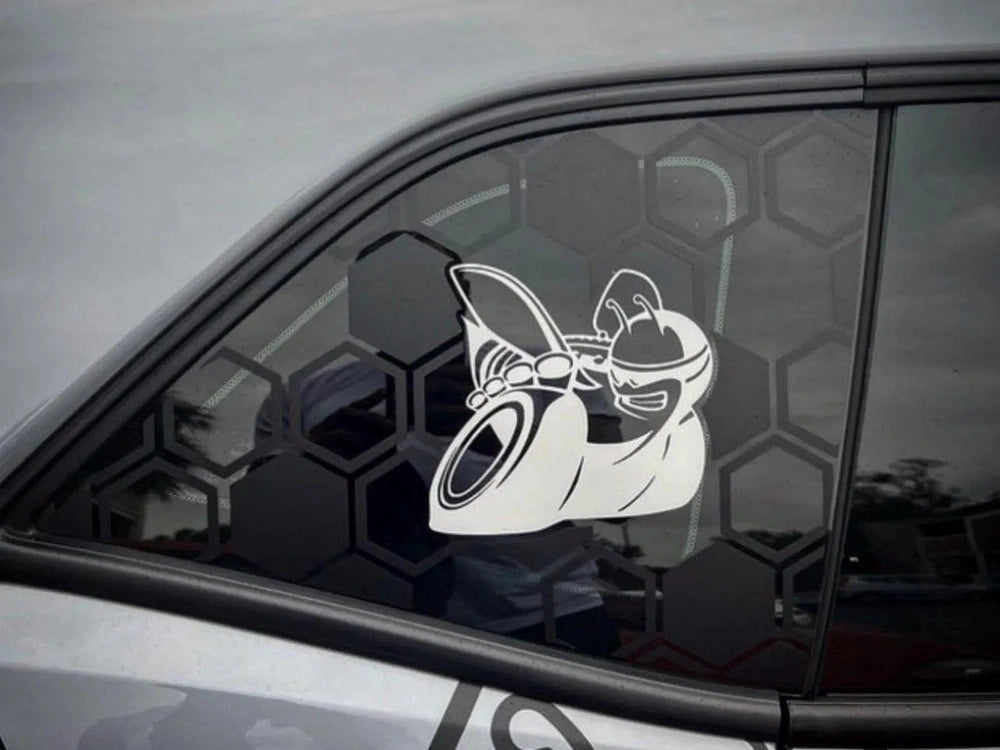 Dodge Challenger quarter window with custom Scat Pack bee logo decal, showcasing hexagonal pattern and sleek design on gray vehicle exterior