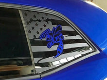 Load image into Gallery viewer, Challenger quarter window decal featuring American flag design with stars and stripes, overlaid with blue angry hornet logo, applied to bright blue car exterior