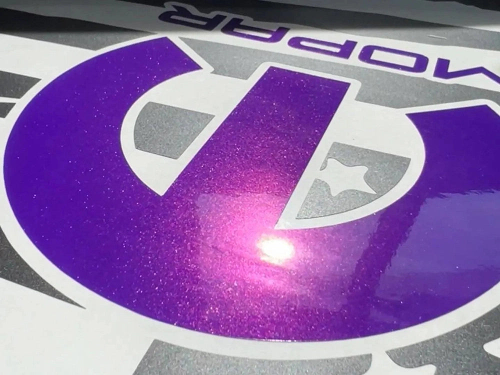Purple MOPAR logo decal for Dodge Challenger quarter window, showcasing vibrant color and glossy finish. Custom vinyl accessory enhances vehicle appearance with precise fit and premium quality.
