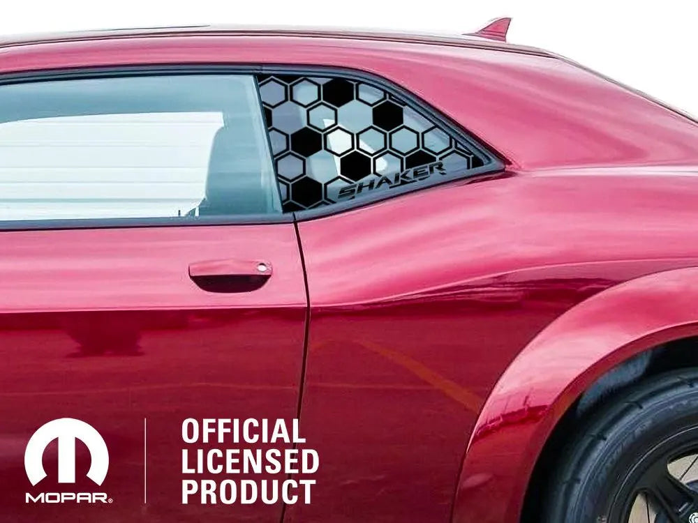 Red Dodge Challenger with honeycomb pattern quarter window decal, showcasing custom Shaker logo design. Mopar official licensed product label visible, highlighting the authenticity of the accessory for muscle car enthusiasts.
