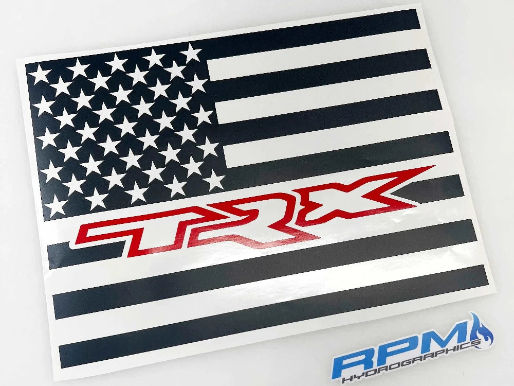 Custom RAM truck rear sliding window decal featuring black and white American flag design with red TRX logo, showcasing patriotic style and brand loyalty for 2009+ RAM pickup owners
